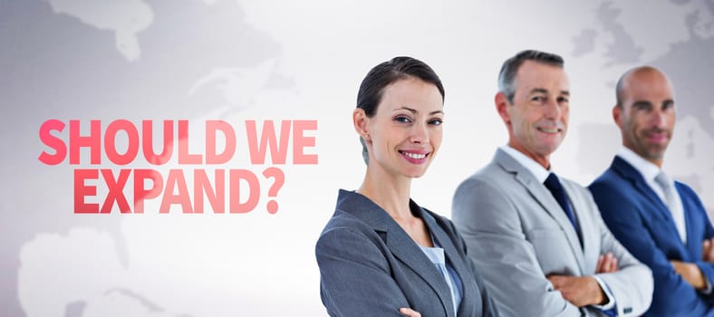 Business colleagues smiling at camera against grey background