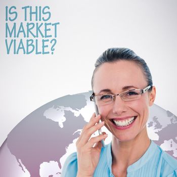 Smiling businesswoman having a phone call against grey background