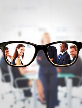 Glasses against business team smiling at the camera in a meeting