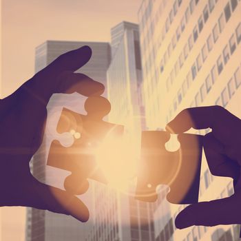 Businessman pointing with his finger against low angle view of skyscrapers