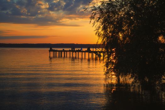 Reflections and jetty at Lake Starnberg  in the evening light