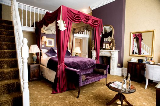 Stylish bedroom with a dresser, stool and luxury bed