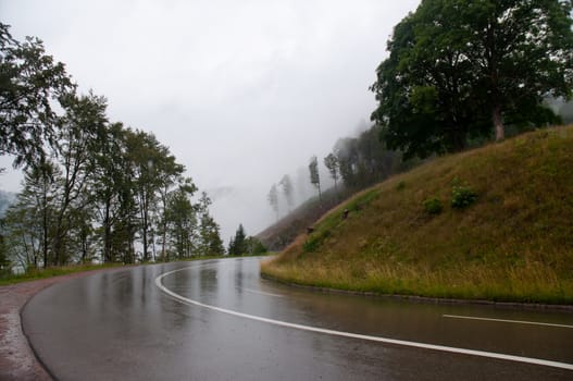 Wet road and fog in the mountains in the Black Forest. Germany.