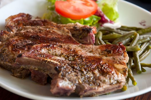 Grilled steak meat with salad .