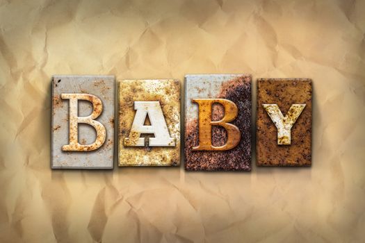 The word "BABY" written in rusty metal letterpress type on a crumbled aged paper background.