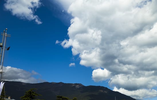 Clouds over mountains majestically float towards the sea