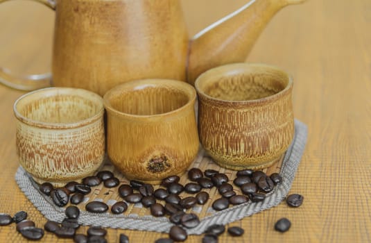 Soft focus image of coffee beans and coffee cups set on wooden background.Vintage style.(soft focus)