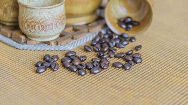 Soft focus image of coffee beans and coffee cups set on wooden background.Vintage style.(soft focus)