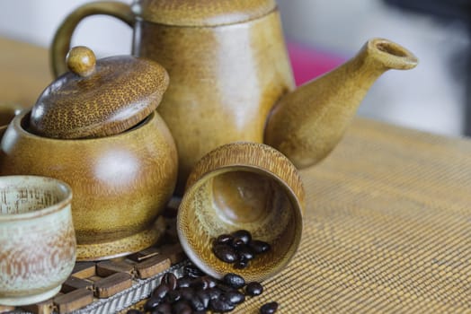 Soft focus image of coffee beans and coffee cups set on wooden background.Vintage style.(soft focus)