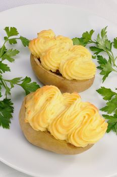 Baked potatoes stuffed with vegetables on a platter