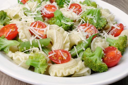 Pasta with broccoli, tomatoes, green beans and parmesan