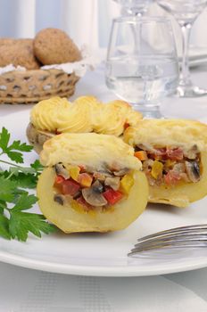 Baked potatoes stuffed with vegetables on a platter