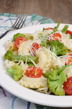 Pasta with broccoli, tomatoes, green beans and parmesan