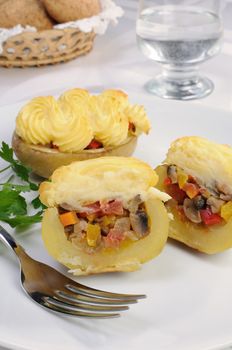 Baked potatoes stuffed with vegetables on a platter