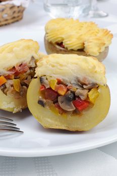 Baked potatoes stuffed with vegetables on a platter