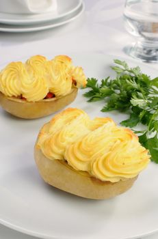 Baked potatoes stuffed with vegetables on a platter