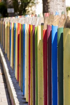 Fence of colourful pencils outside a preschool. Nice depth of field.