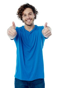 Happy young man showing thumbs up gesture