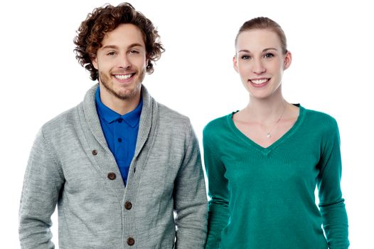 Stylish young smiling couple posing to camera 