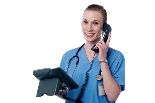 Happy female physician attending a phone call
