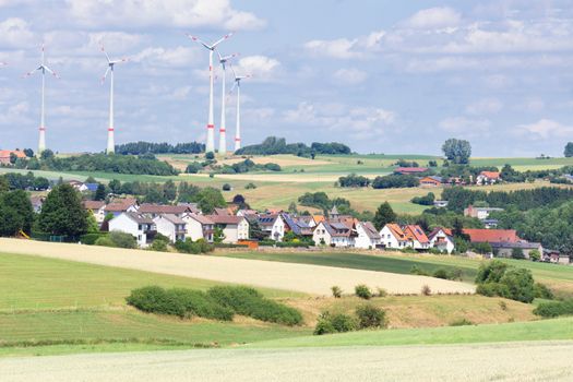 German village with houses, windmills and grain fields