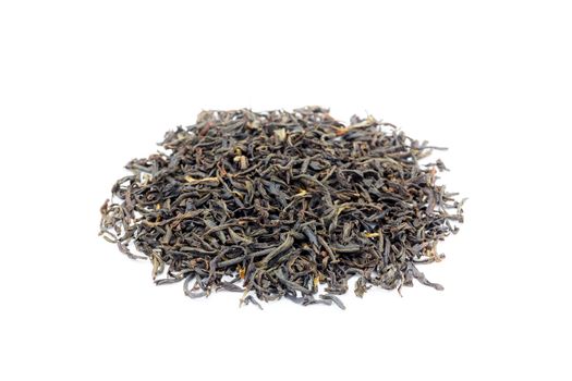 Heap of loose black tea Assam isolated on white background