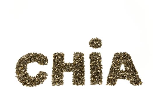 Word CHIA containing chia seeds isolated on white background