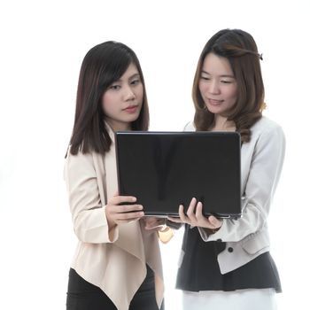 Two asian business woman in office, business talking with notebook