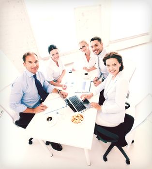 business concept - friendly business team having meeting in office