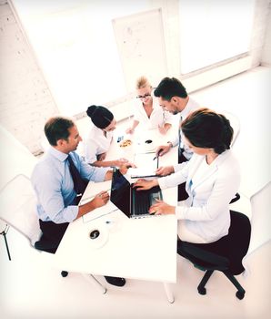 business concept - friendly business team having meeting in office