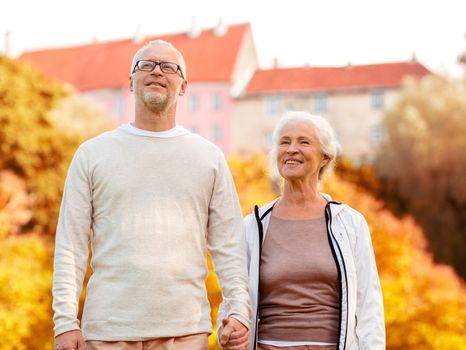 family, age, tourism, travel and people concept - senior couple in city park