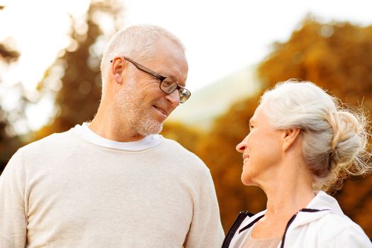 family, age, tourism, travel and people concept - senior couple in city park