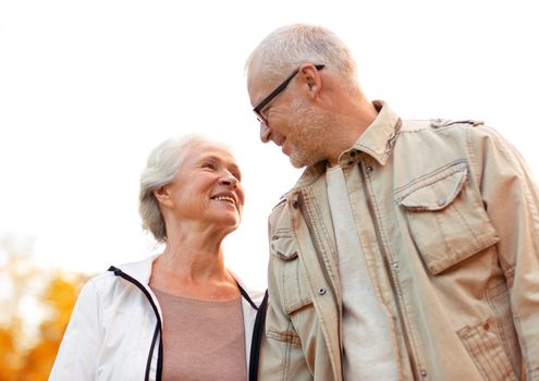 family, age, tourism, travel and people concept - senior couple in park