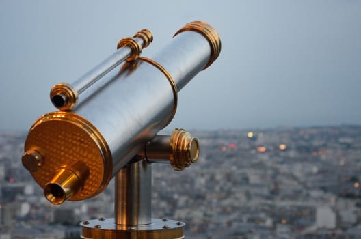 Vintage Telescope looking over city at dusk