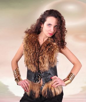 young girl with curly hair in a fur coat on an abstract background