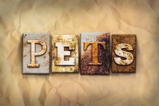 The word "PETS" written in rusty metal letterpress type on a crumbled aged paper background.