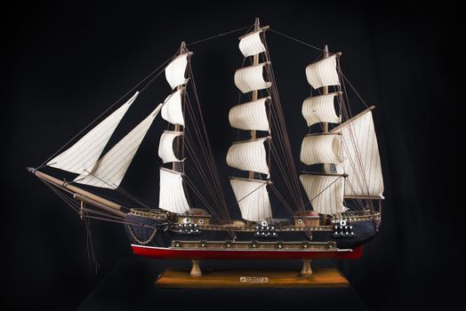 Highly detailed XVIII century frigate model isolated over black background