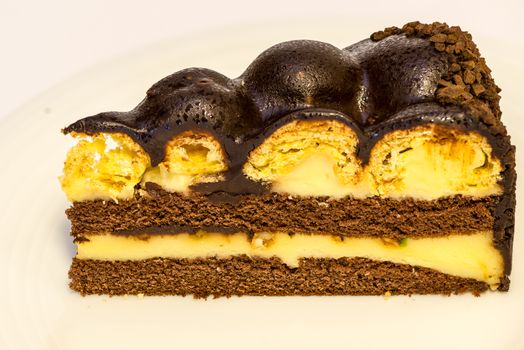 a piece of isolated vanilla and chocolate cake