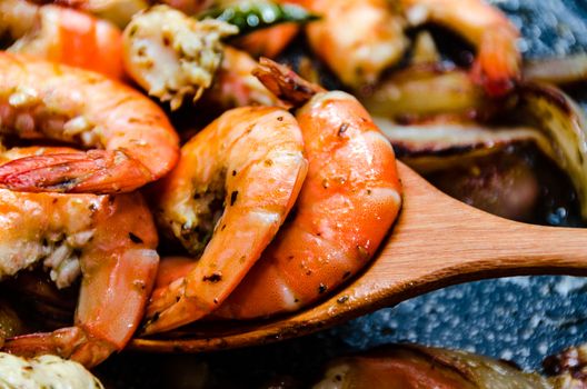 Closeup of shrimps on pan with herbs