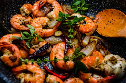 Shrimps on pan with fresh herbs