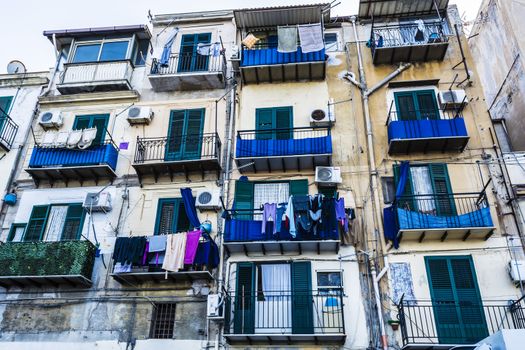 Building exterior with windows and balconies in Palermo, Sicily, Italy