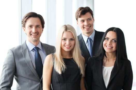 Happy business team of coworkers in office