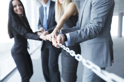 Businessmen pulling chain, teamwork togetherness concept