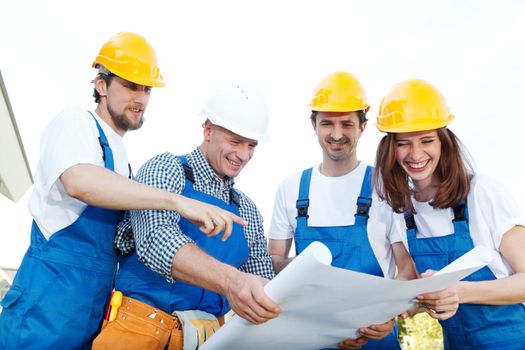 team of workmen looking at house design