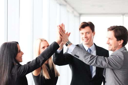 Happy business people hands giving high five 