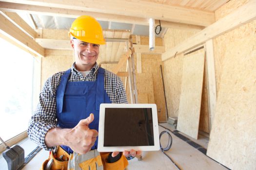 portrait of workman with tablet and thumbs up