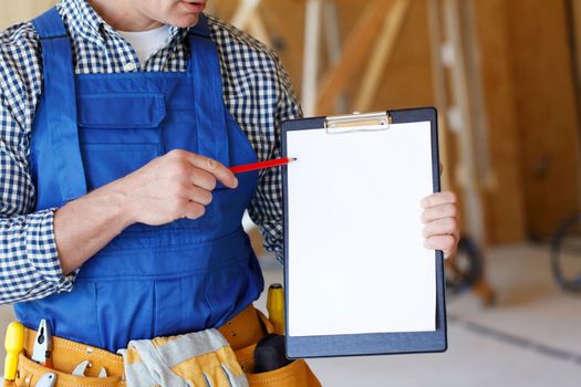 portrait of foreman pointing at white folder plate