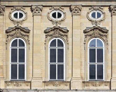 Three arched windows decorated mansion.