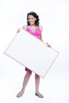 Young smiling woman holding a white board on isolated studio background