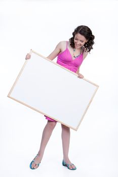 Young smiling woman holding a white board on isolated studio background